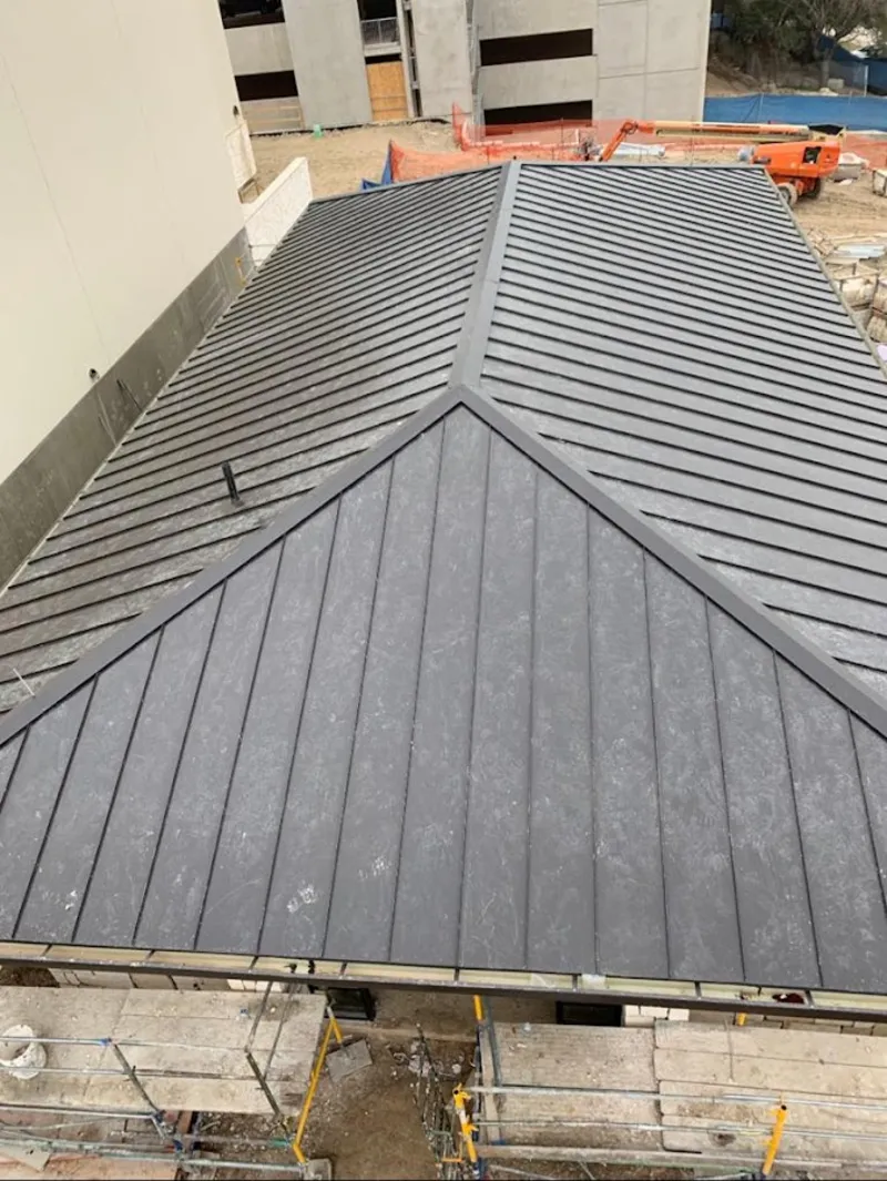 Commercial metal roof construction with crane equipment in Superior