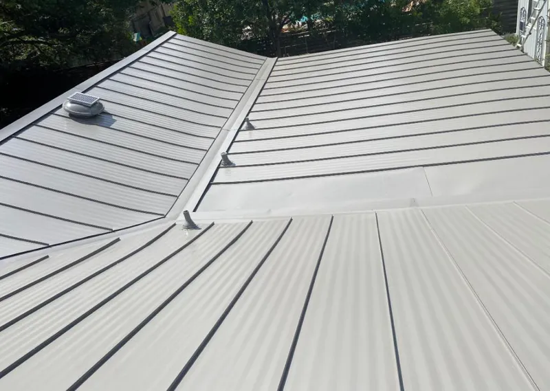 Solar attic fan installed on a metal roof for Roof Ventilation in Superior
